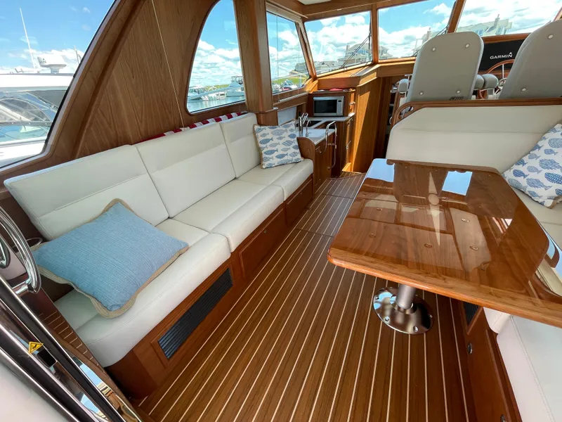 Slide: The Image of 2024 Sabre 43 Salon Express interior with elegant wood finish and plush seating. - 21