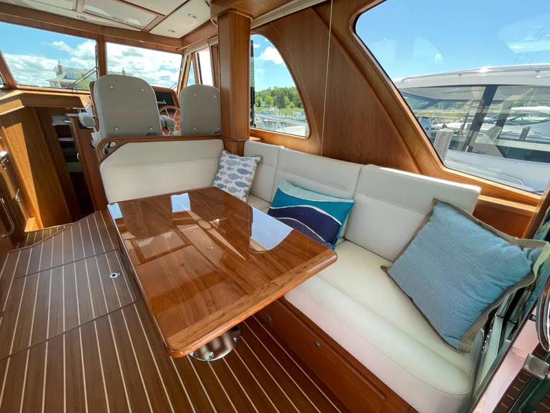 Slide: The Image of 2024 Sabre 43 Salon Express interior with elegant wood finish and plush seating. - 22