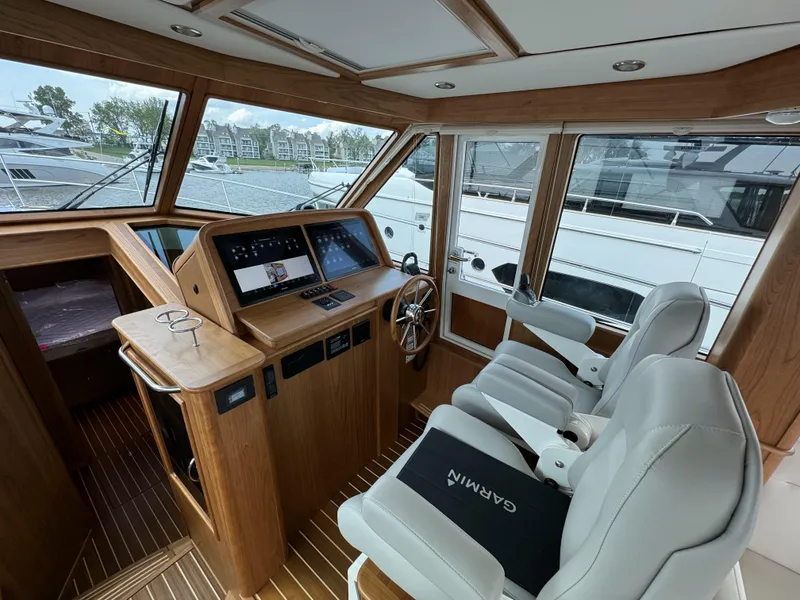 Slide: The Image of 2024 Sabre 43 Salon Express helm with modern controls and luxurious seating. - 24