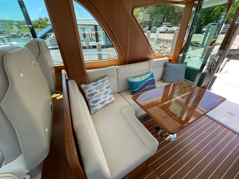 Slide: The Image of 2024 Sabre 43 Salon Express interior with elegant seating and wooden table. - 25