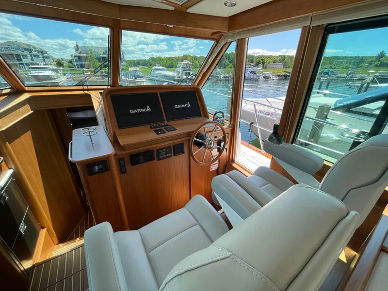 Slide: The Image of 2024 Sabre 43 Salon Express helm with dual Garmin displays and luxurious seating. - 27