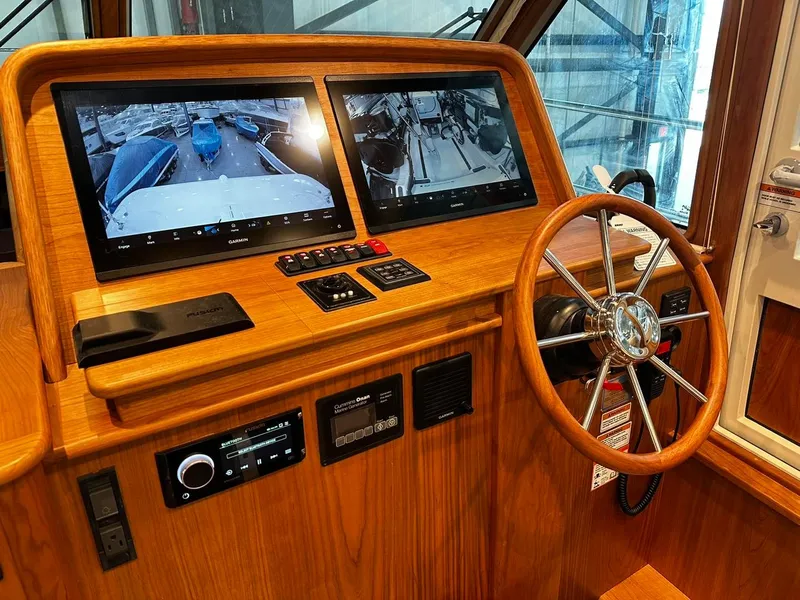 Slide: The Image of 2024 Sabre 43 Salon Express helm with dual screens and wooden steering wheel. - 28