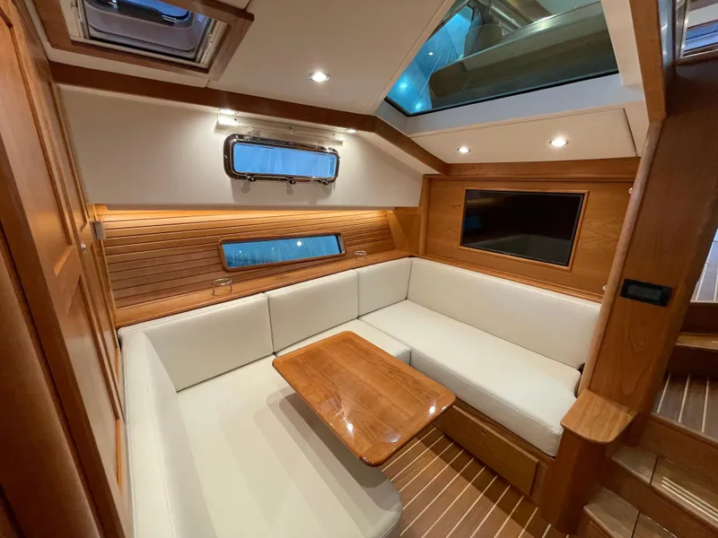 Slide: The Image of 2024 Sabre 43 Salon Express interior with elegant wood finish and cozy seating area. - 34