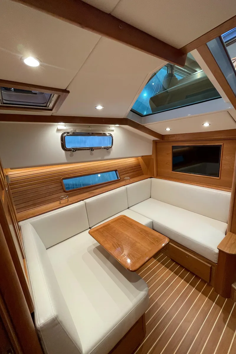 Slide: The Image of 2024 Sabre 43 Salon Express interior with elegant wood finish and plush seating. - 35