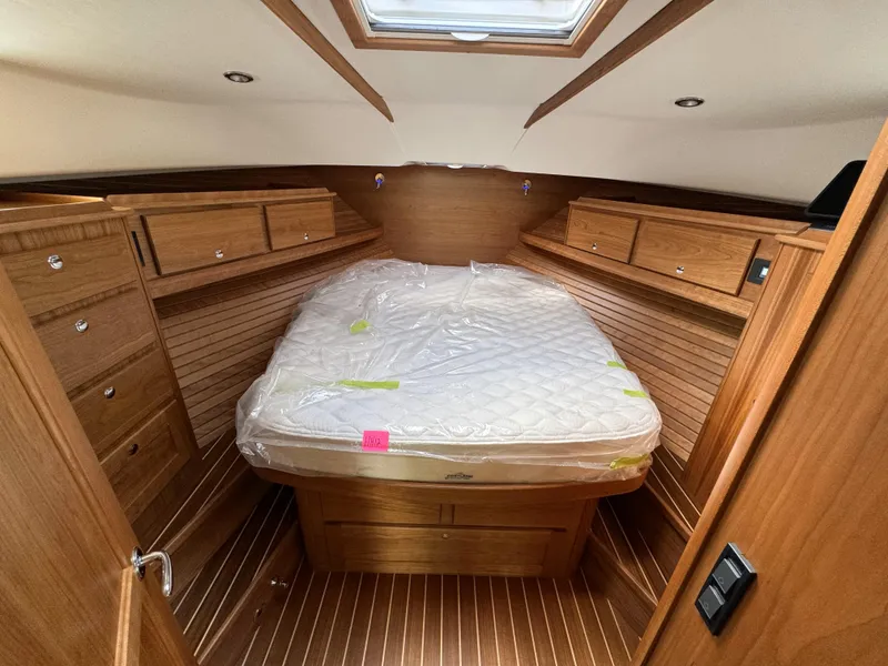 Slide: The Image of 2024 Sabre 43 Salon Express cabin with wood finish and bed. - 36