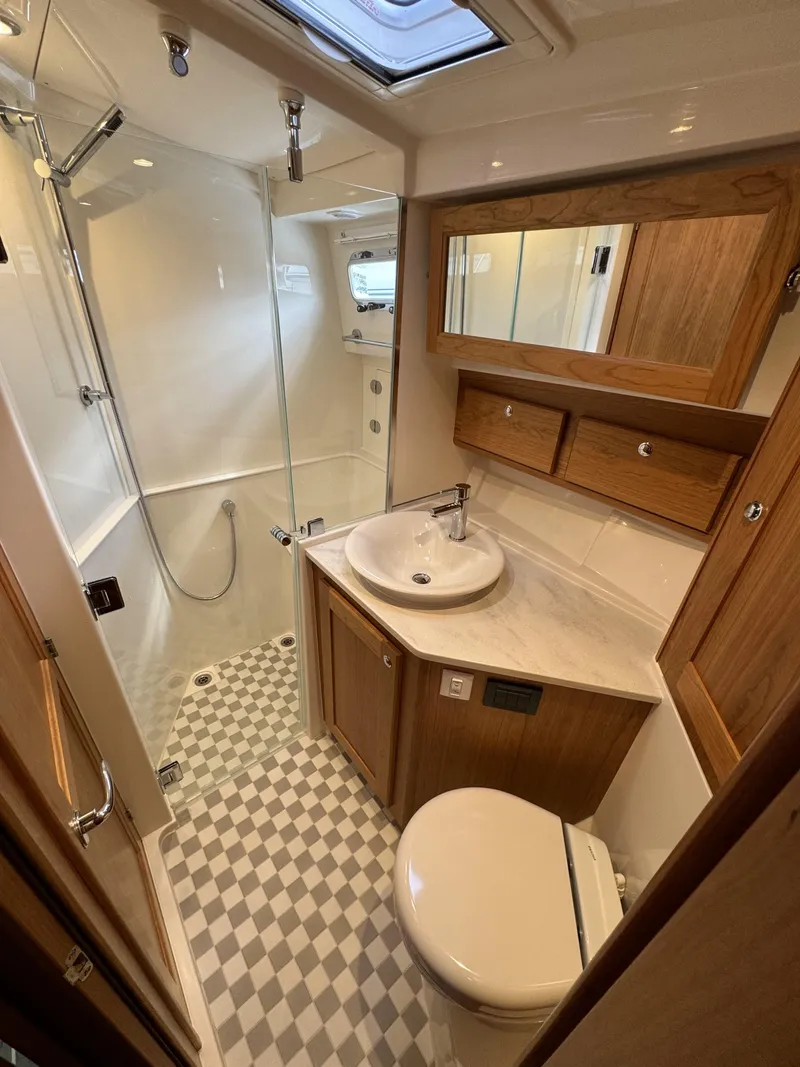 Slide: The Image of 2024 Sabre 43 Salon Express bathroom with modern fixtures and checkered floor. - 37