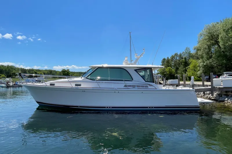 Slide: The Image of 2024 Sabre 43 Salon Express yacht docked on a sunny day. - 9
