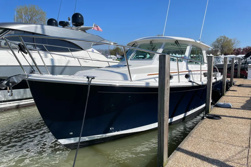 Slide: The Image of 2024 Back Cove 34O boat docked, featuring sleek design and modern amenities. - 11