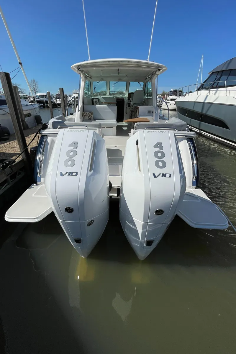 Slide: The Image of 2024 Back Cove 34O boat with twin V10 engines docked in marina. - 16
