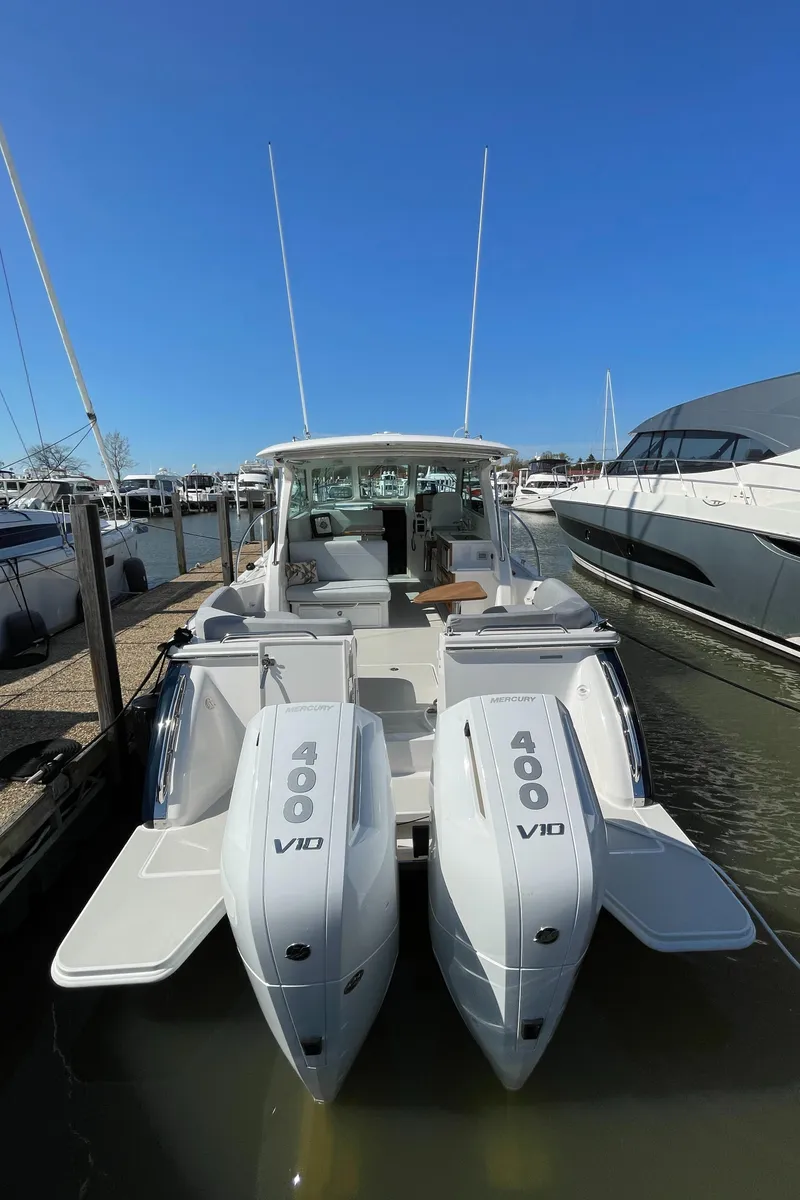 Slide: The Image of 2024 Back Cove 34O boat with dual 400 V10 engines docked in marina. - 17