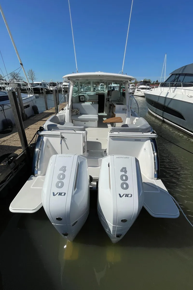 Slide: The Image of 2024 Back Cove 34O boat with dual 400 V10 engines docked at marina. - 18
