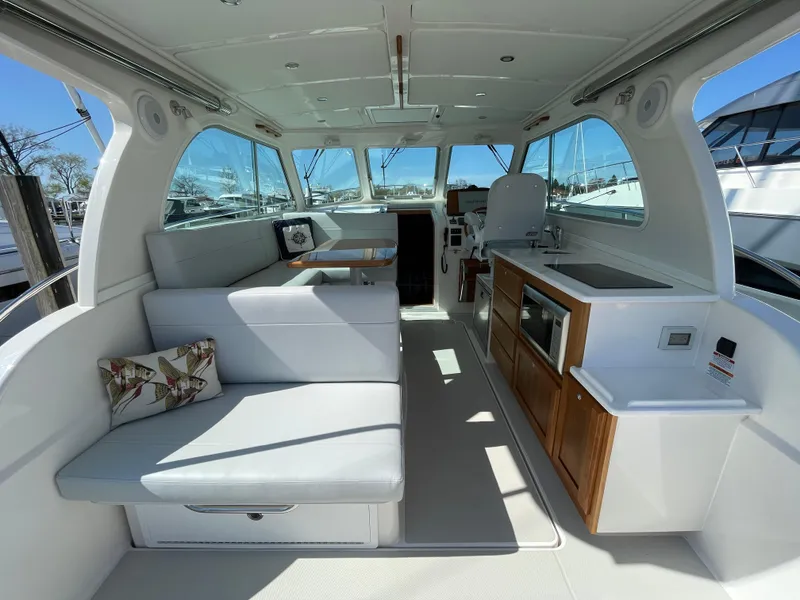 Slide: The Image of Luxurious interior of 2024 Back Cove 34O yacht with seating and kitchenette. - 21