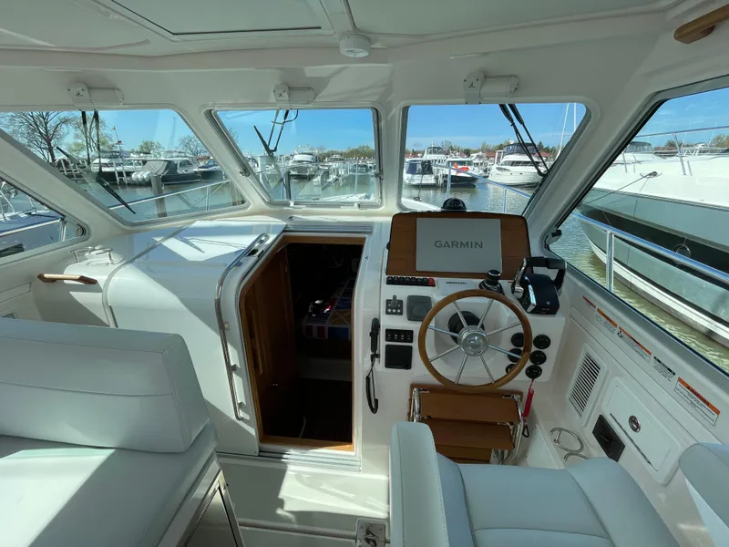 Slide: The Image of 2024 Back Cove 34O helm with Garmin navigation, docked in marina. - 23