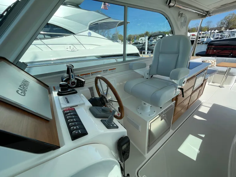 Slide: The Image of 2024 Back Cove 34O yacht helm with modern controls and comfortable seating. - 26