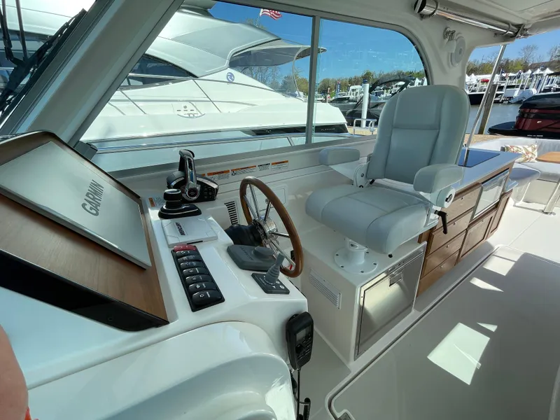 Slide: The Image of 2024 Back Cove 34O helm with modern controls and comfortable seating. - 27