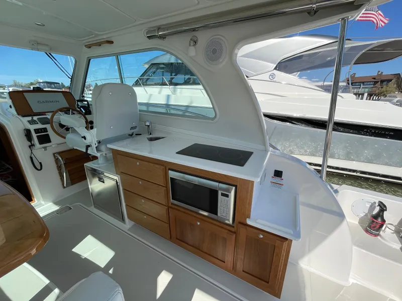 Slide: The Image of 2024 Back Cove 34O yacht interior with modern kitchen and helm station. - 29