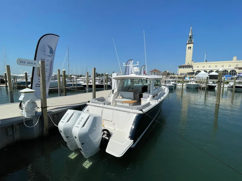 Slide: The Image of 2024 Back Cove 34O boat docked at marina with clear blue sky. - 3
