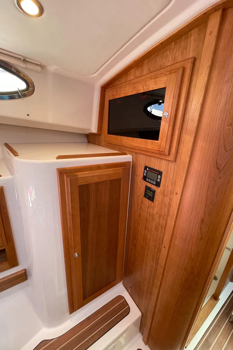 Slide: The Image of 2024 Back Cove 34O interior with wooden cabinetry and modern design elements. - 46
