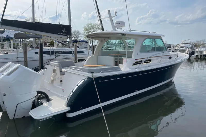 Slide: The Image of 2024 Back Cove 34O boat docked in marina, featuring sleek design and modern amenities. - 8