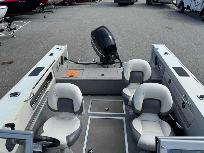 Slide: The Image of 2012 Starcraft Superfisherman 176 boat interior with four seats and motor. - 5