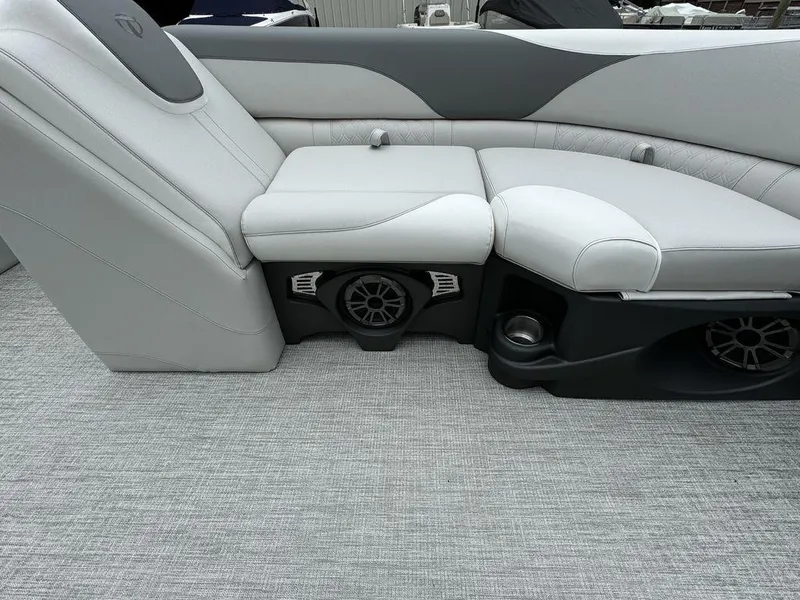Slide: The Image of 2025 Tahoe LTZ 2385 VRB boat interior with gray seating and built-in speakers. - 10