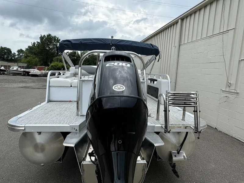 Slide: The Image of 2025 Tahoe LTZ 2385 VRB pontoon boat with powerful outboard motor, docked outdoors. - 4