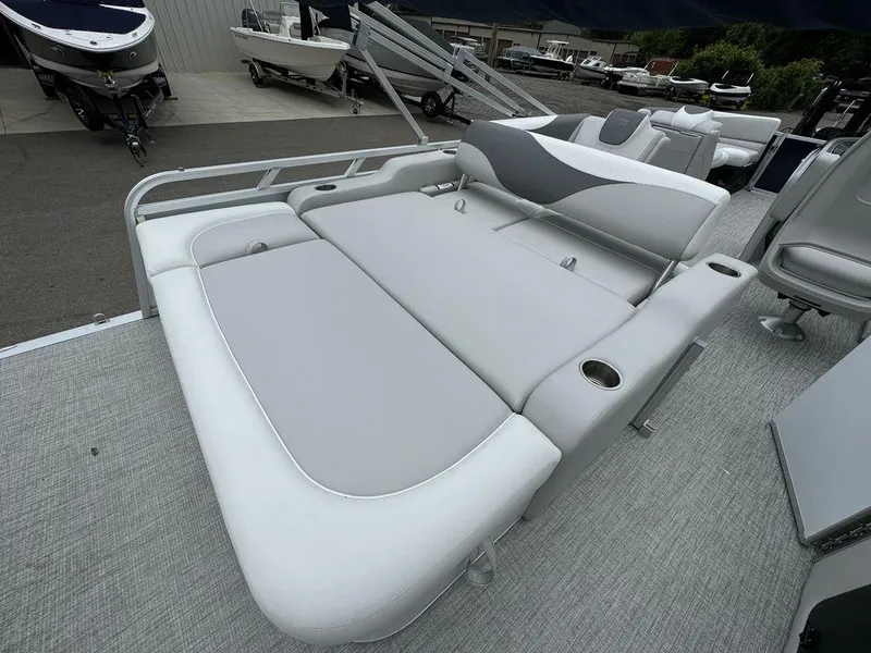 Slide: The Image of 2025 Tahoe LTZ 2385 VRB pontoon boat with spacious gray seating and cup holders. - 5