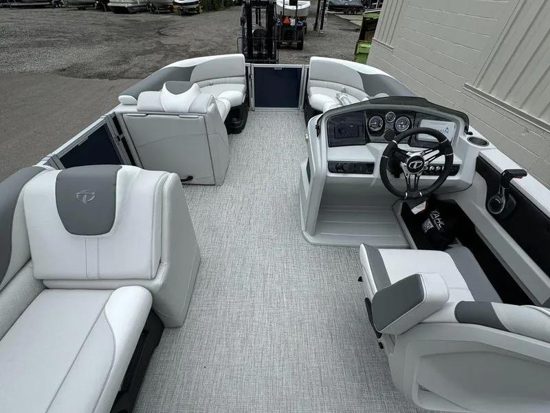 Slide: The Image of 2025 Tahoe LTZ 2385 VRB pontoon boat interior with modern seating and steering console. - 7