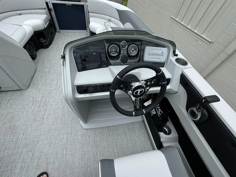 Slide: The Image of 2025 Tahoe LTZ 2385 VRB boat interior with steering wheel and Garmin display. - 9