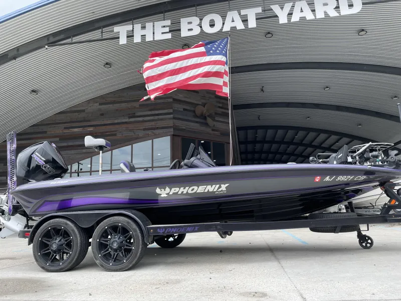 Slide: The Image of 2022 Phoenix 919 ProXP boat at The Boat Yard with American flag. - 0