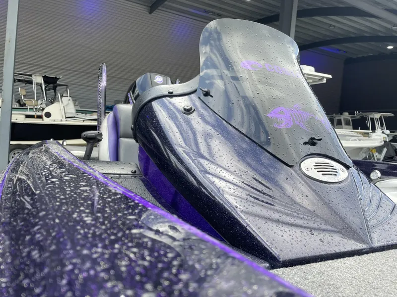 Slide: The Image of 2022 Phoenix 919 ProXP boat with raindrops on windshield, in a covered marina. - 13