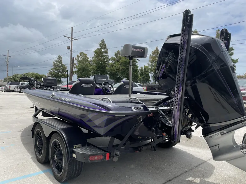 Slide: The Image of 2022 Phoenix 919 ProXP boat on trailer, parked outdoors under cloudy sky. - 15