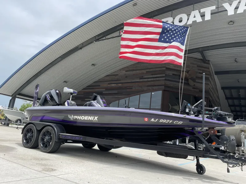 Slide: The Image of 2022 Phoenix 919 ProXP boat with American flag at boat yard. - 16