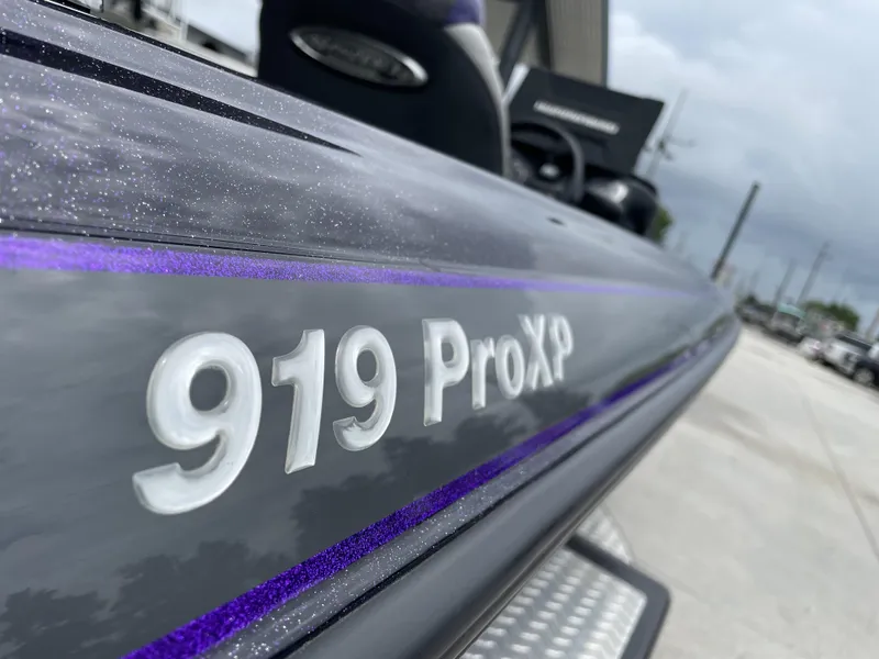 Slide: The Image of Close-up of 2022 Phoenix 919 ProXP boat with metallic finish and purple accents. - 17