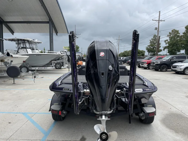 Slide: The Image of 2022 Phoenix 919 ProXP boat with powerful outboard motor in a dealership lot. - 19