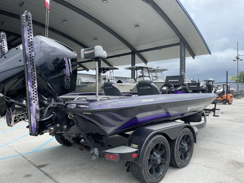Slide: The Image of 2022 Phoenix 919 ProXP boat with Mercury engine at a dealership. - 2