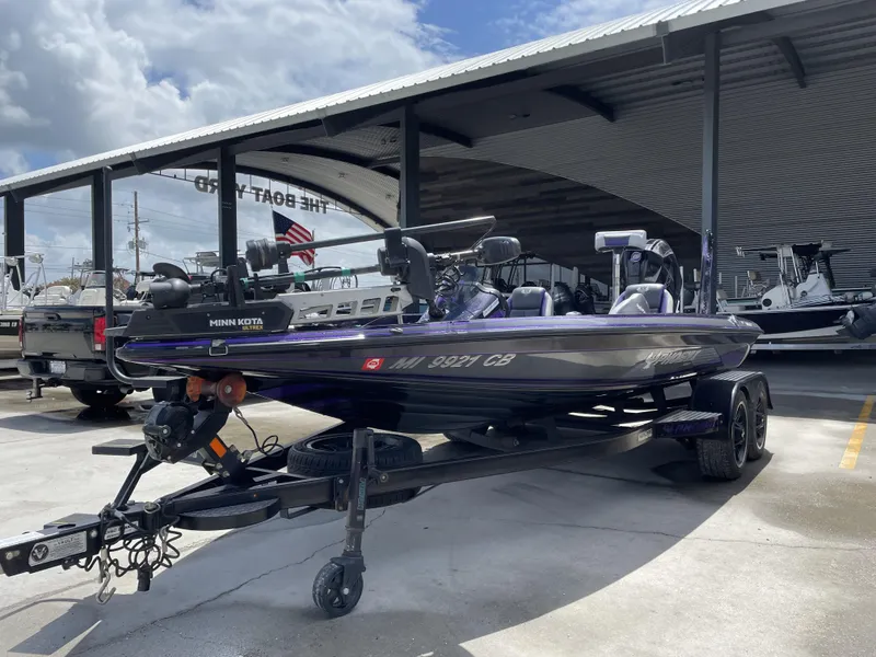 Slide: The Image of 2022 Phoenix 919 ProXP boat on trailer at dealership under cloudy sky. - 24