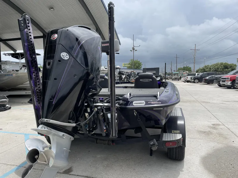 Slide: The Image of 2022 Phoenix 919 ProXP boat with powerful outboard motor in a parking lot. - 3