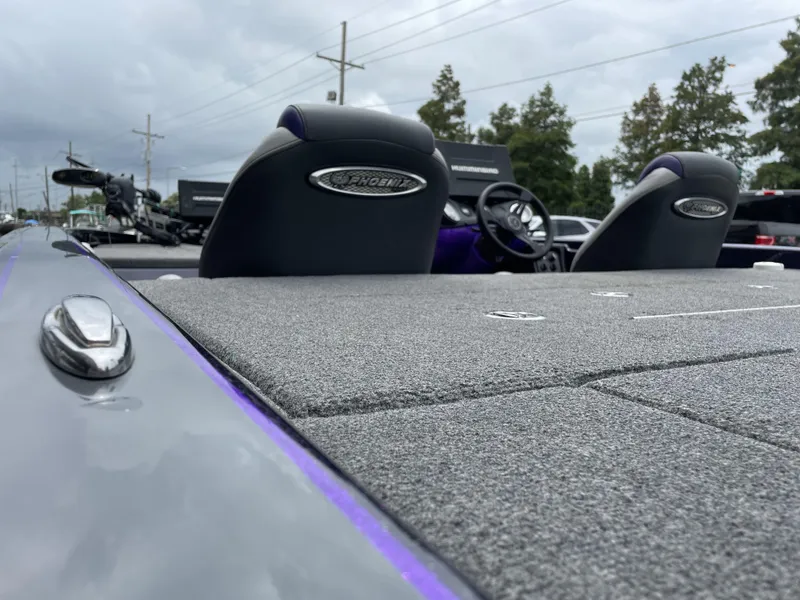 Slide: The Image of 2022 Phoenix 919 ProXP boat interior with carpeted deck and dual seats. - 6