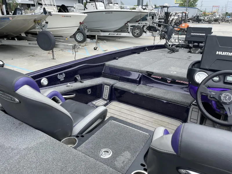 Slide: The Image of 2022 Phoenix 919 ProXP boat interior with modern dashboard and seating. - 8