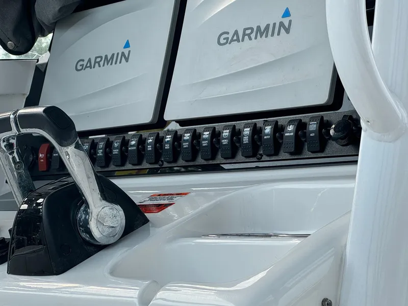 Slide: The Image of 2018 Sea Hunt Gamefish 27 dashboard with Garmin navigation displays and control panel. - 2