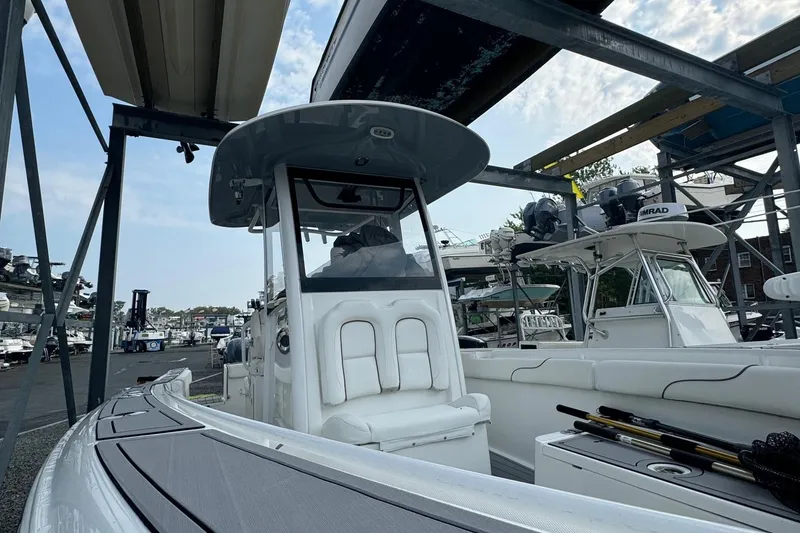 Slide: The Image of 2018 Sea Hunt Gamefish 27 boat docked at marina, featuring sleek design and fishing equipment. - 3