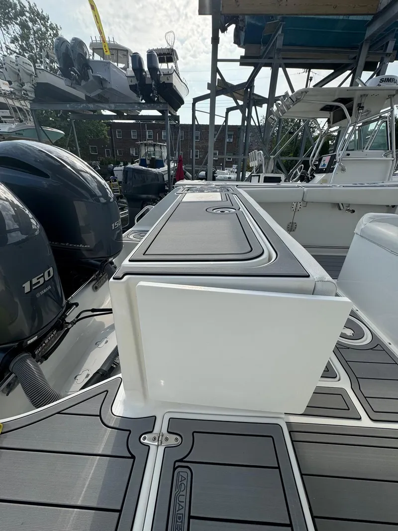 Slide: The Image of 2018 Sea Hunt Gamefish 27 boat deck with dual 150 engines, docked at marina. - 6