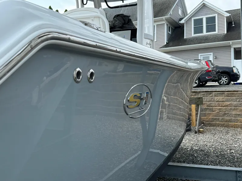 Slide: The Image of 2018 Sea Hunt Gamefish 27 boat, side view, parked near a house. - 7