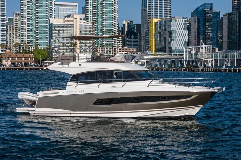 The Image of 2015 Prestige 420 yacht cruising near city skyline. - 1