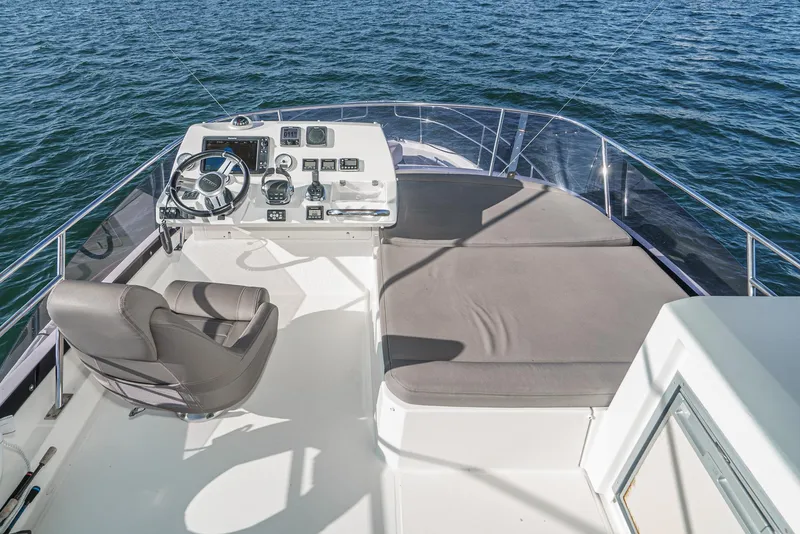 Slide: The Image of Flybridge of 2015 Prestige 420 yacht with helm and seating, overlooking the ocean. - 10