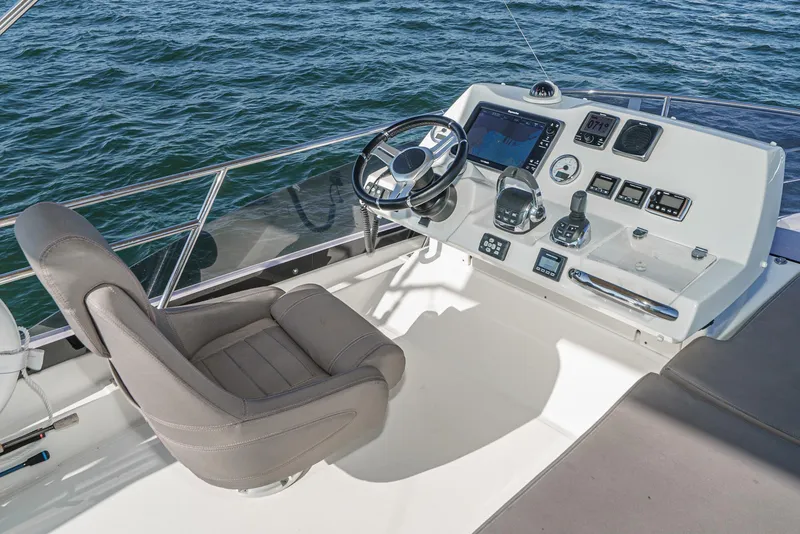 Slide: The Image of Prestige 420 yacht helm station, 2015 model, with steering wheel and navigation controls. - 11