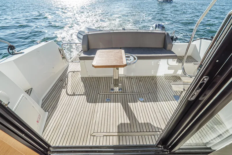 Slide: The Image of Prestige 420 yacht deck, 2015 model, with seating and table overlooking the ocean. - 13