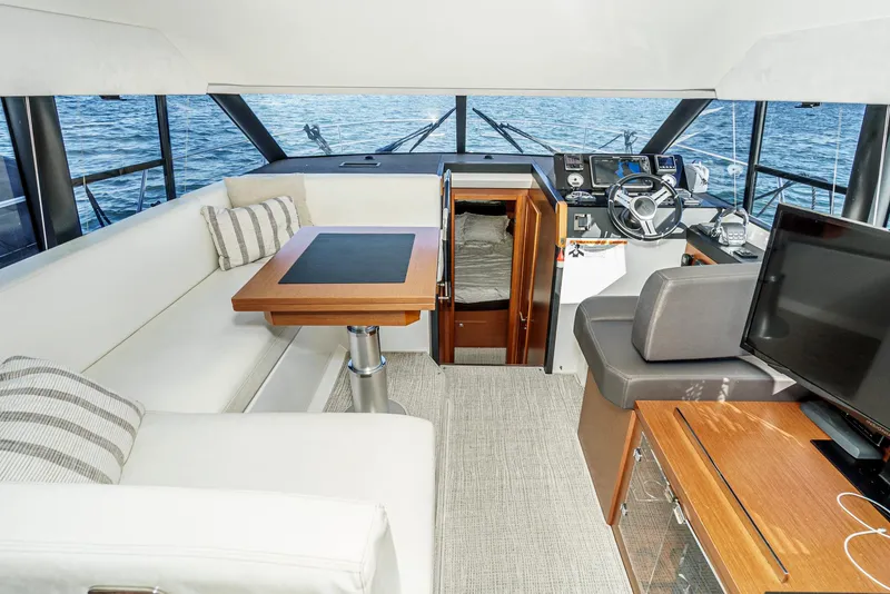 Slide: The Image of Luxurious interior of 2015 Prestige 420 yacht with seating, table, and helm. - 23