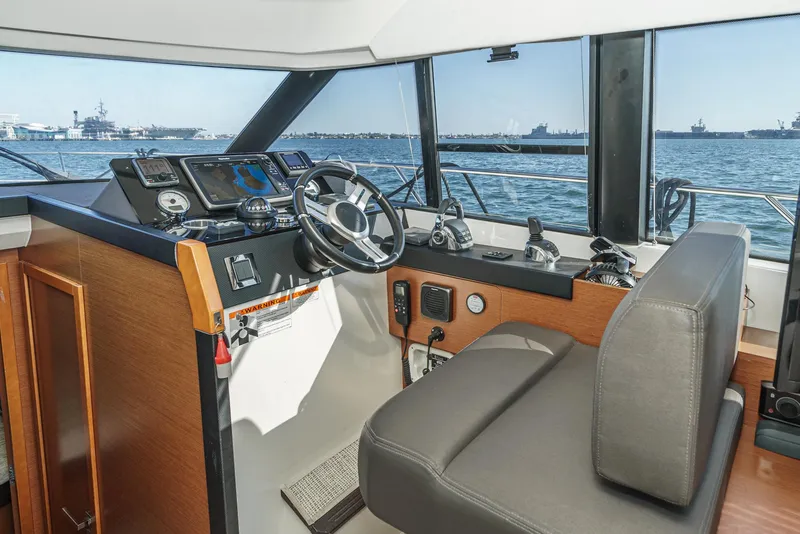 Slide: The Image of Prestige 420 yacht helm, 2015 model, featuring modern navigation equipment and ocean view. - 26